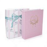 Pink baby album with decorative cover and matching box on a white background
