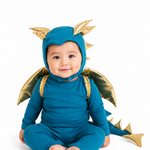 Baby wearing a blue dragon costume with gold accents on a white background