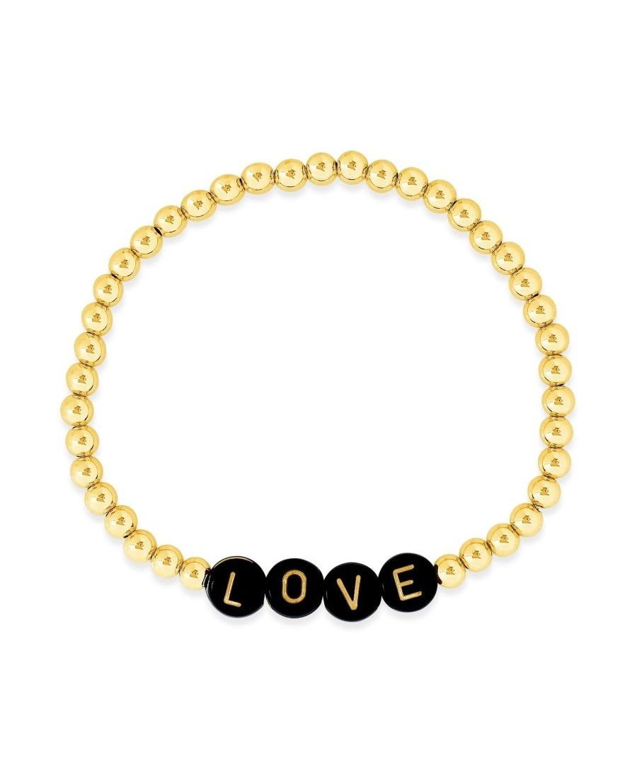 Name bracelet stacked with simple gold beaded bracelets on left model's wrist and heart bracelet with gold beads on right model's wrist