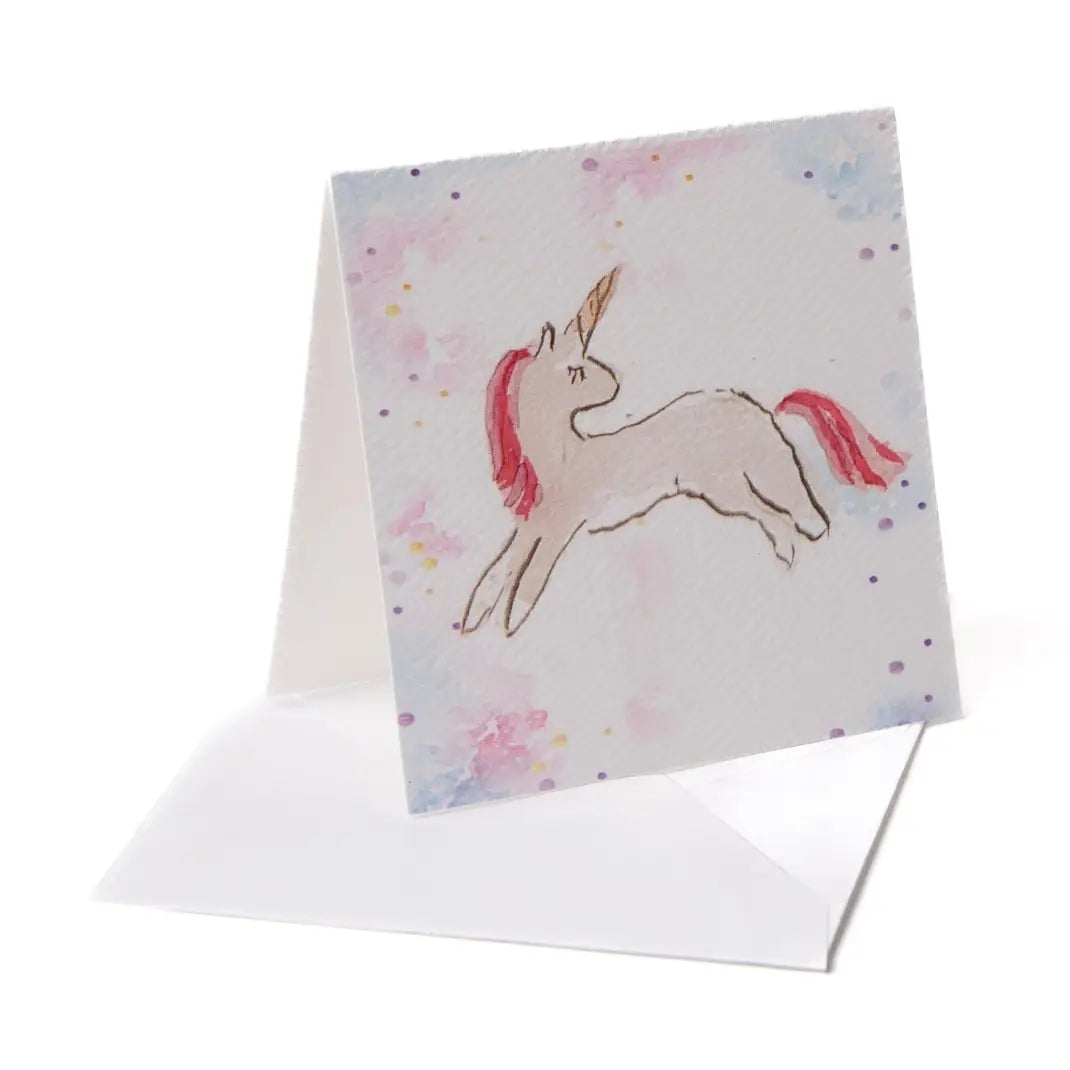 Greeting card with a unicorn illustration on a watercolor background