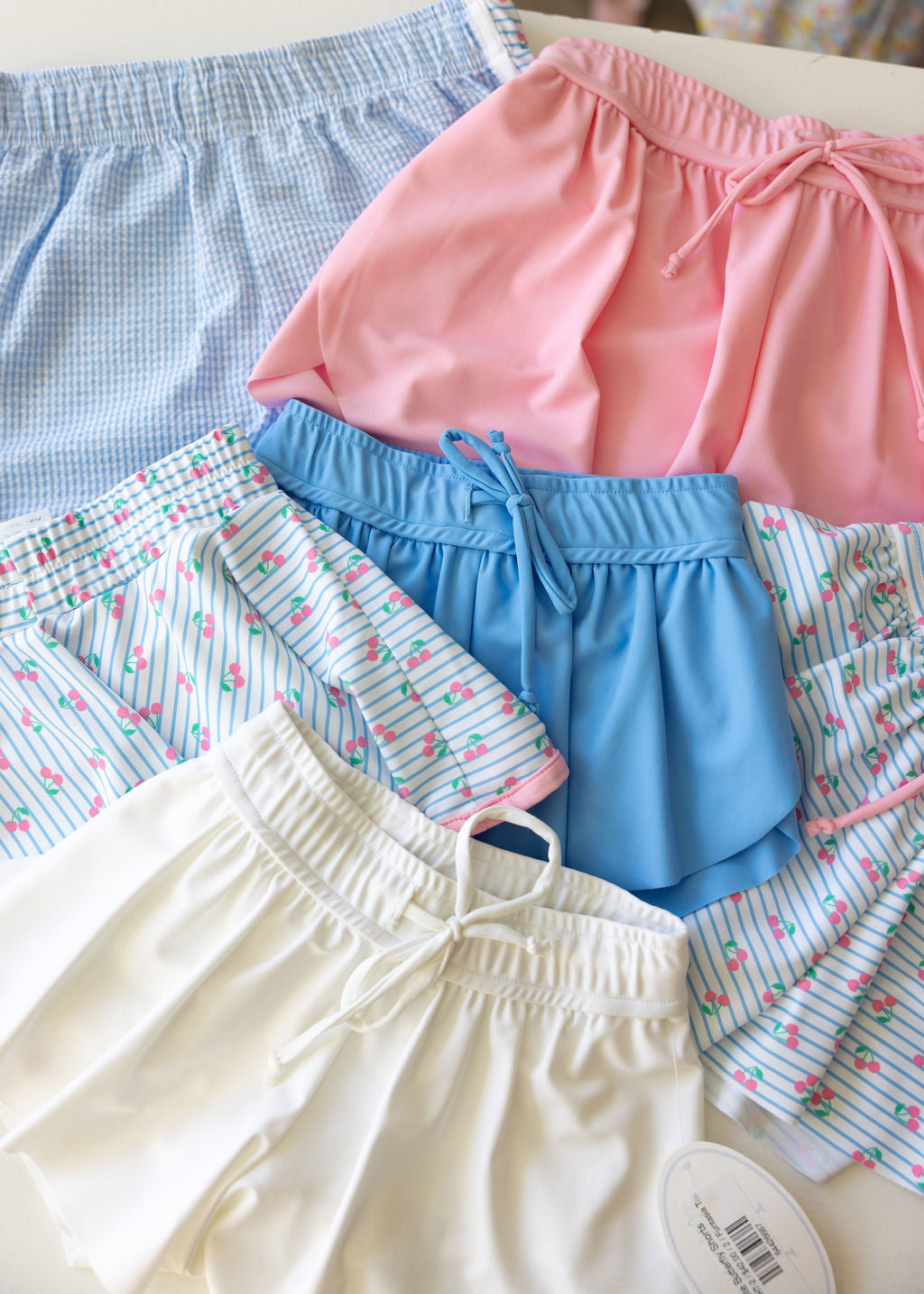 Collection of colorful athletic shorts on a white surface