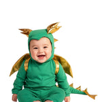 Baby wearing a green dragon costume on a white background