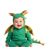 Baby wearing a green dragon costume on a white background