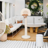 Outdoor living space with a white sofa, basketball hoop, and decorative elements.