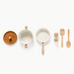 Set of ceramic pots and pans with wooden handles and utensils on a white background