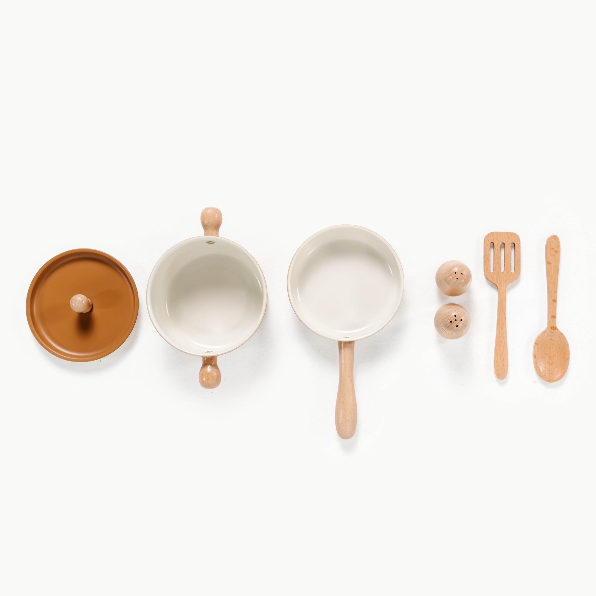 Set of ceramic pots and pans with wooden handles and utensils on a white background
