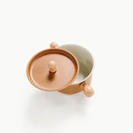 Two ceramic containers with lids on a white background