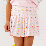 Skirt with colorful pattern worn by a person on a white background