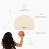 Basketball hoop with a woman holding a basketball, featuring text on product features.