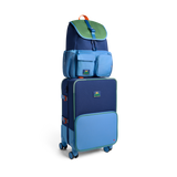 Stack of blue suitcases with a green backpack on a white background