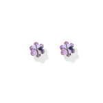 A pair of small flower-shaped stud earrings with iridescent lavender-purple petals and gold-toned prongs, set against a clean white background.