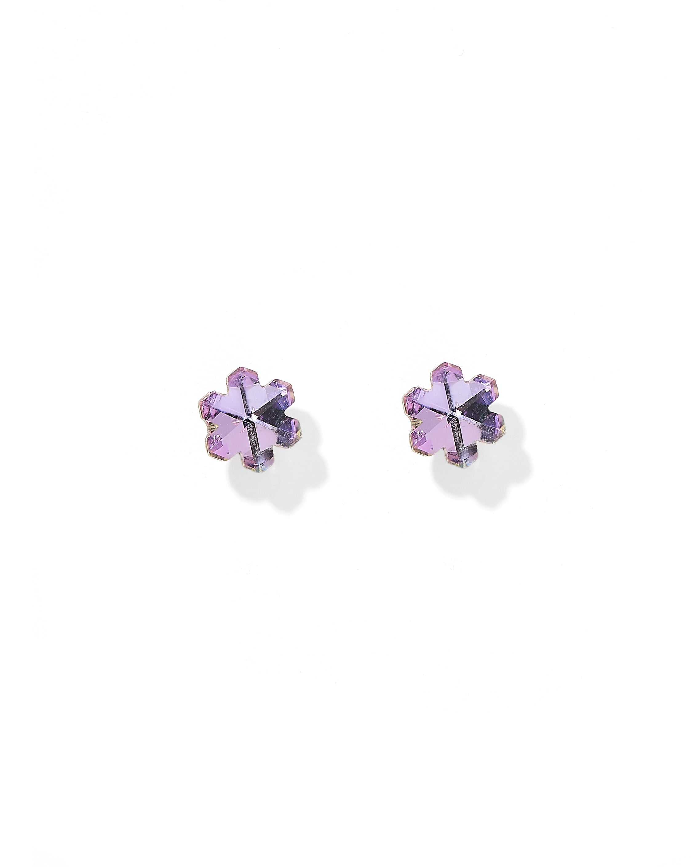 A pair of small flower-shaped stud earrings with iridescent lavender-purple petals and gold-toned prongs, set against a clean white background.