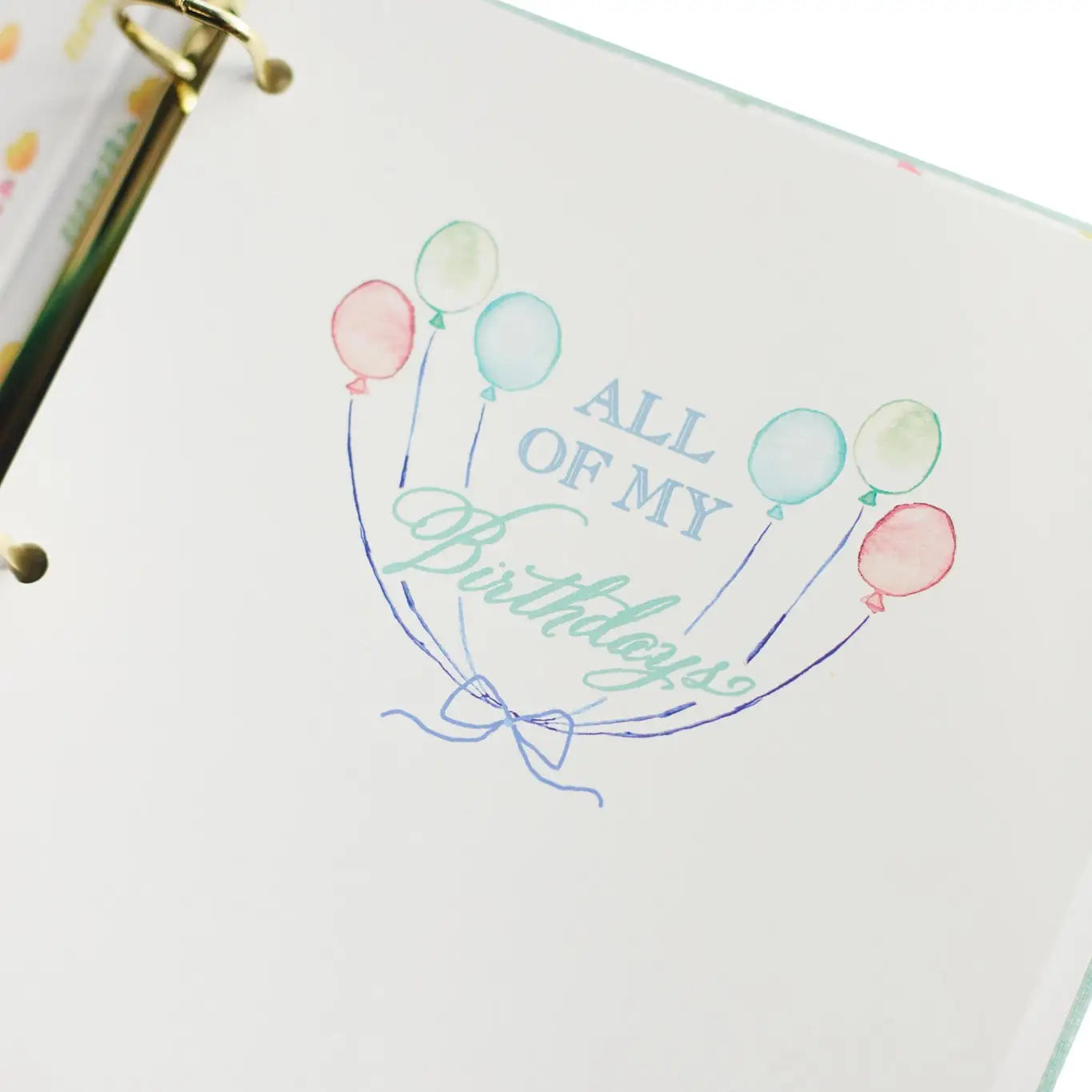 Notebook with decorative cover featuring balloons and text on a white background