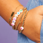 LeMel Kid's Custom Everyday Stretch Bracelet- White Bead With Rainbow Letters