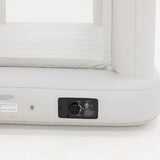 Close-up of a white inflatable mattress with a control panel on a white background