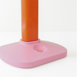 Pink base with an orange pole on a white background