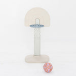 Children's basketball hoop with floral-patterned ball on a white background