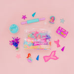 Colorful mermaid-themed stationery items on a pink background