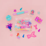 Colorful mermaid-themed stationery items on a pink background