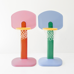 Two colorful children's basketball hoops on a white background