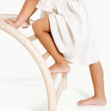 Person sitting on a white chair with a white blanket draped over them, on a white background